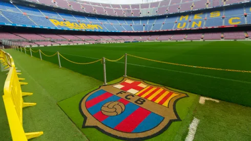 BARCELONA, SPAIN - MAY 23, 2021: Football Club Barcelona emblem on grass of empty Camp Nou stadium field