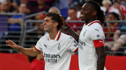 Christian Pulisic of AC Milan celebrates with teammate Rafael Leao after scoring the team's second goal during a Pre-Season Friendly match between FC Barcelona and AC Milan at M&T Bank Stadium on August 06, 2024 in Baltimore, Maryland.