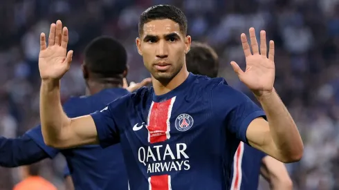 Achraf Hakimi of Paris Saint-Germain holds his hands up the FC Internazionale fans as he celebrates scoring his team's first goal during the UEFA Champions League Final 2025 between Paris Saint-Germain and FC Internazionale Milano at Munich Football Arena on May 31, 2025 in Munich, Germany.