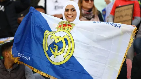 A fan of Real Madrid pose for a photo with a flag prior to the FIFA Club World Cup Morocco 2022 Semi Final match between Al Ahly v Real Madrid CF at Prince Moulay Abdellah on February 08, 2023.