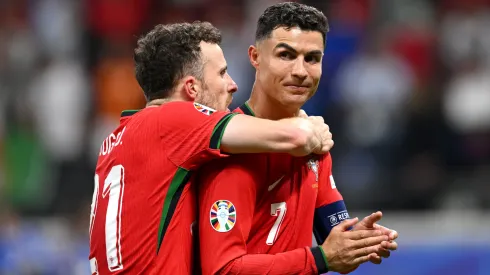 Diogo Jota and Cristiano Ronaldo of Portugal celebrate following the team's victory in the penalty shoot out during the UEFA EURO 2024 round of 16 match between Portugal and Slovenia at Frankfurt Arena on July 01, 2024 in Frankfurt am Main, Germany.