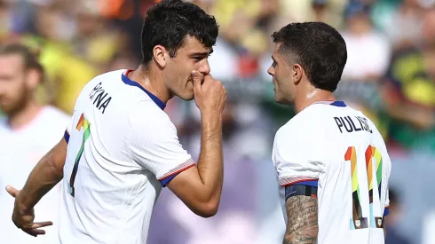 : Gio Reyna #7 and Christian Pulisic #10 of United States speak during the first half against Colombia at Commanders Field on June 08, 2024 in Landover, Maryland.
