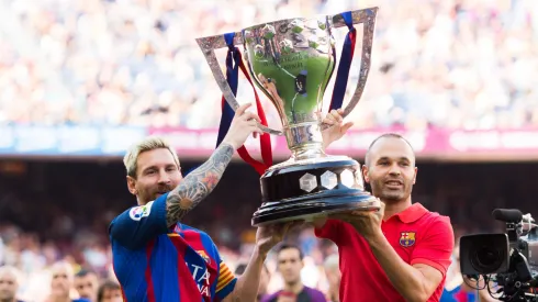 Lionel Messi and Andres Iniesta of FC Barcelona lift up the Spanish La Liga 2015-2016 season trophy before the La Liga match between FC Barcelona and Real Betis Balompie at Camp Nou on August 20, 2016.