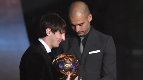 Lionel Messi receives the men's player of the year award from his club coach Pep Guardiola during the FIFA Ballon d'or Gala on January 10, 2011.