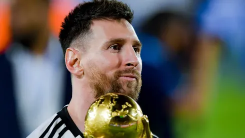 Lionel Messi of Argentina holds the FIFA World Cup trophy.