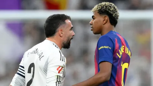 Dani Carvajal of Real Madrid clashes with Lamine Yamal of FC Barcelona.