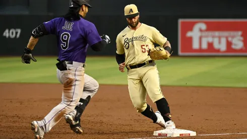PHOENIX, ARIZONA - MAY 06: Christian Walker #53 of the Arizona Diamondbacks gets an unassisted force out at first base on a ground ball hit by Connor Joe #9 of the Colorado Rockies during the second inning at Chase Field on May 06, 2022 in Phoenix, Arizona. (Photo by Norm Hall/Getty Images)