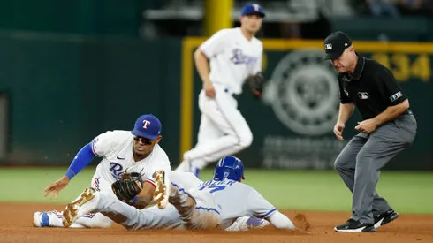 ARLINGTON, TEXAS - MAY 12: Hunter Dozier #17 of the Kansas City Royals steals second base as Andy Ibanez #77 of the Texas Rangers applies the tag in the fourth inning at Globe Life Field on May 12, 2022 in Arlington, Texas. (Photo by Tim Heitman/Getty Images)