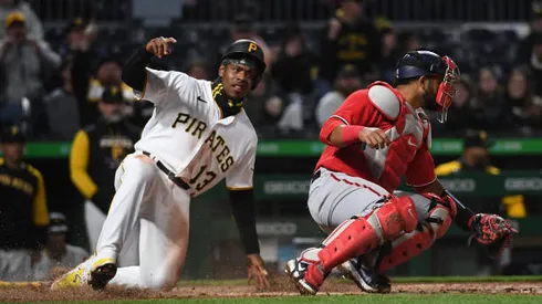 PITTSBURGH, PA - APRIL 16: Ke'Bryan Hayes #13 of the Pittsburgh Pirates slides in safely past Keibert Ruiz #20 of the Washington Nationals to score a run on a RBI single by Michael Chavis #2 (not pictured) in the fifth inning during the game at PNC Park on April 16, 2022 in Pittsburgh, Pennsylvania. (Photo by Justin Berl/Getty Images)