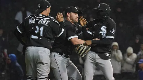 CHICAGO, ILLINOIS - MAY 03: (L-R) Reese McGuire #21, Liam Hendriks #31, and Tim Anderson #7 of the Chicago White Sox celebrate after their win over the Chicago Cubs at Wrigley Field on May 03, 2022 in Chicago, Illinois. The White Sox defeated the Cubs 3-1. (Photo by Nuccio DiNuzzo/Getty Images)