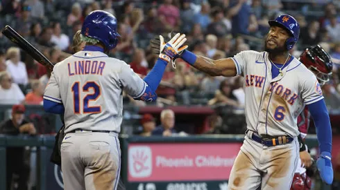 PHOENIX, ARIZONA - APRIL 24: Starling Marte #6 of the New York Mets high fives Francisco Lindor #12 after scoring a run against the Arizona Diamondbacks during the sixth inning of the MLB game at Chase Field on April 24, 2022 in Phoenix, Arizona. (Photo by Christian Petersen/Getty Images)