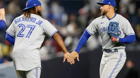 NEW YORK, NEW YORK - APRIL 13: Vladimir Guerrero Jr. #27 and George Springer #4 of the Toronto Blue Jays celebrate after defeating the New York Yankees at Yankee Stadium on April 13, 2022 in New York City. The Blue Jays defeated the Yankees 6-4. (Photo by Jim McIsaac/Getty Images)