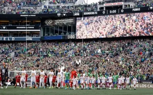 SEATTLE, WASHINGTON - MAY 04: Players of the Seattle Sounders and Pumas make their way to center field during 2022 Scotiabank Concacaf Champions League Final Leg 2 at Lumen Field on May 04, 2022 in Seattle, Washington. (Photo by Steph Chambers/Getty Images)