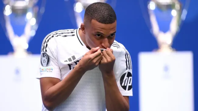 Real Madrid new signing, Kylian Mbappe kisses the Real Madrid badge as he is unveiled at Estadio Santiago Bernabeu on July 16, 2024 in Madrid, Spain. Photo by David Ramos/Getty Images