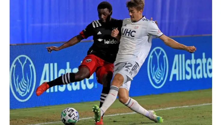 Chris Odoi-Atsem of DC United (left) and Justin Rennicks of New England Revolution fight for the ball (Getty).
