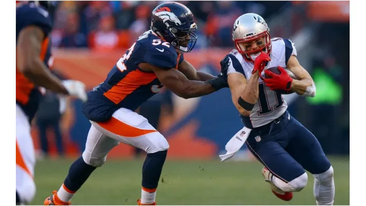 Julian Edelman getting past the Broncos' defense. (Getty)
