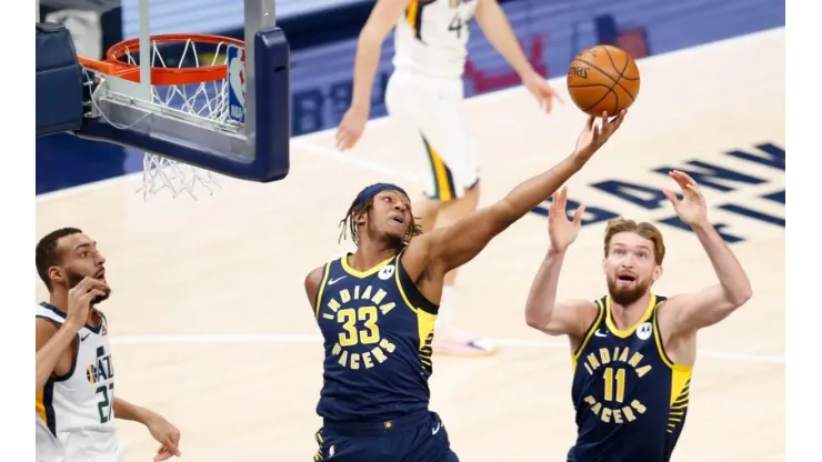 Myles Turner #33 of the Indiana Pacers reaches for the ball after Rudy Gobert #27 of the Utah Jazz misses the shot . (Getty)
