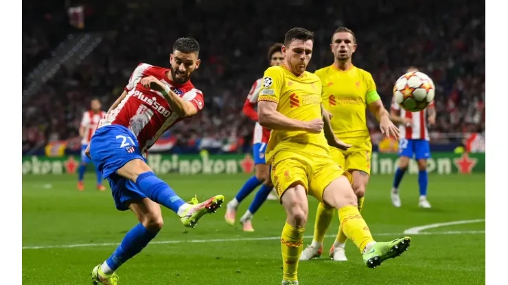 Yannick Carrasco of Atletico de Madrid competes for the ball with James Milner of Liverpool FC during the UEFA Champions League group B match
