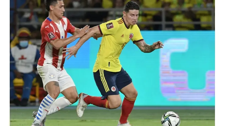 James Rodriguez of Colombia and Matias Rojas of Paraguay fight for the ball.
