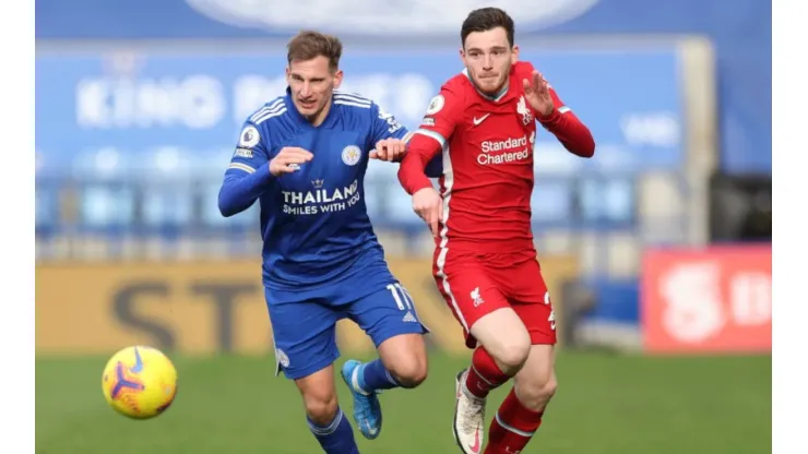 Marc Albrighton of Leicester (left) fights for ball possession against Andrew Robertson of Liverpool
