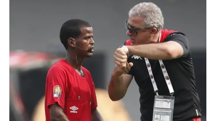 Tunisia head coach Mondher Kebaier points his watch to complain to Zambian referee Janny Sikazwe for ending the Mali vs Tunisia game prematurely.
