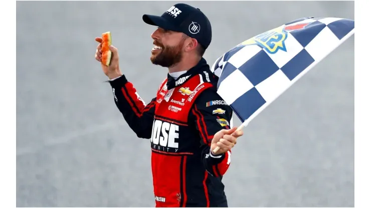 Chastain celebrates his victory at Talladega with a piece of watermelon he broke in his hand
