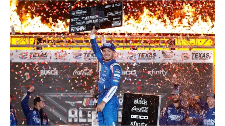 Kyle Larson raises his award for winning the Nascar All-Star Race
