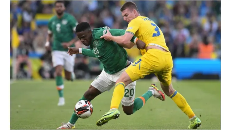 Chiedozie Ogbene of Republic of Ireland is tackled by Oleksandr Syrota of Ukraine
