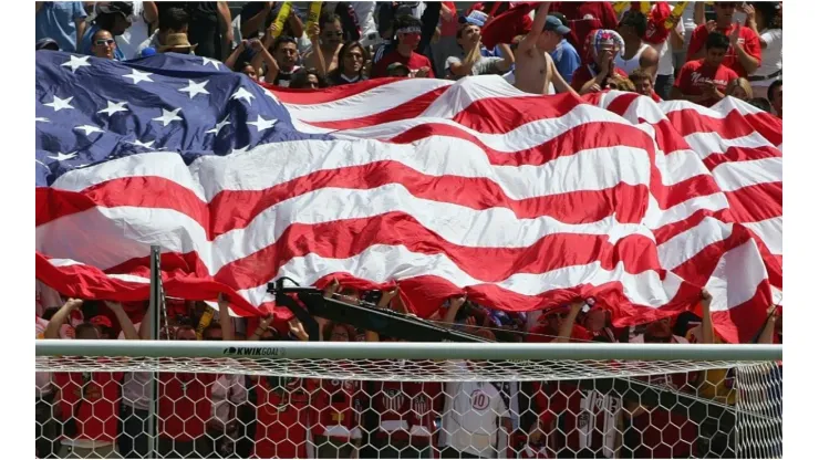 Fans hold up the American flag during a game
