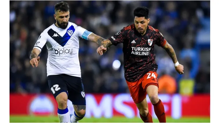 Lucas Pratto of Velez fights for the ball with Enzo Perez of River Plate
