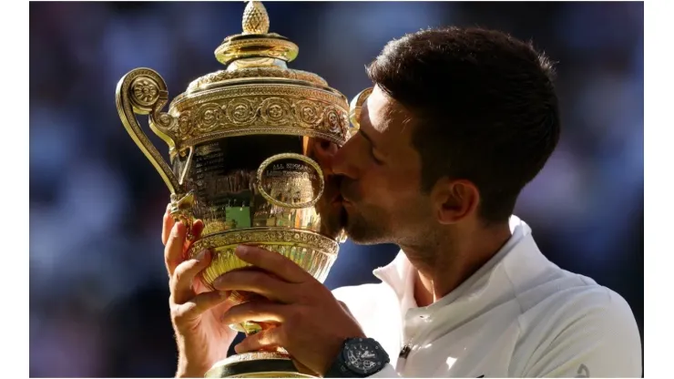 Novak Djokovic of Serbia kisses the Wimbledon trophy
