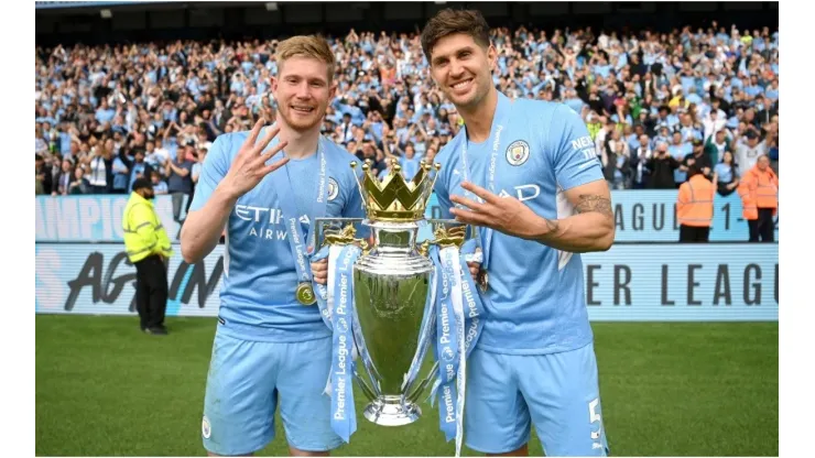 Kevin De Bruyne and John Stones of Manchester City celebrate with the Premier League trophy
