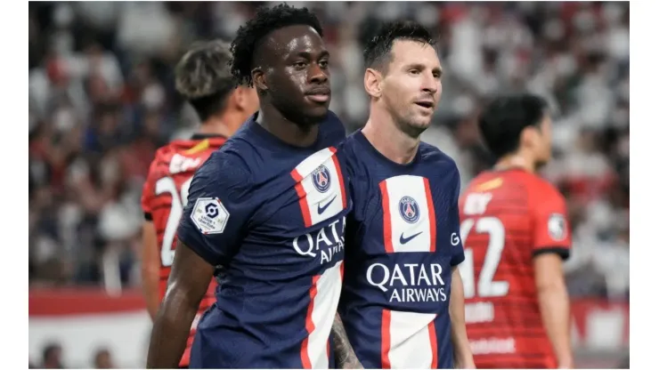 Arnaud Kalimuendo (L) of Paris Saint-Germain celebrates with Lionel Messi (R)
