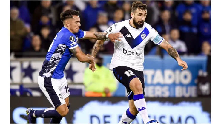 Lucas Pratto of Velez fights for the ball with Enzo Diaz of Talleres
