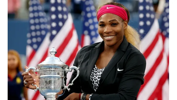 Serena Williams of the United States celebrates with the US Open trophy in 2014
