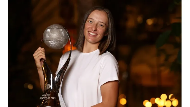 Iga Swiatek of Poland poses with the Chris Evert Trophy.
