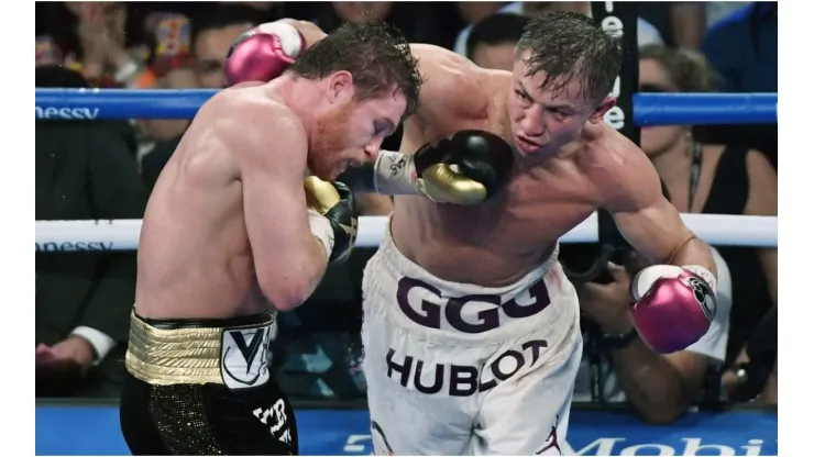 Gennady Golovkin (R) throws a right at Canelo Alvarez
