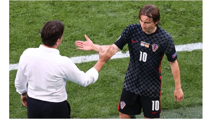 Luka Modric of Croatia shakes hands with coach Zlatko Dalic
