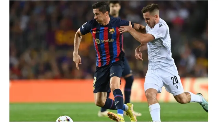 Robert Lewandowski of FC Barcelona battles for possession with Pavel Bucha of Viktoria Plzen
