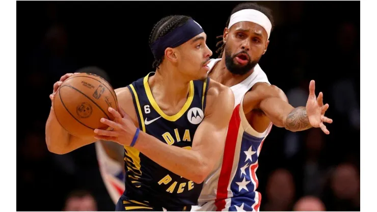 Andrew Nembhard of the Indiana Pacers tries to keep the ball from Patty Mills of the Brooklyn Nets
