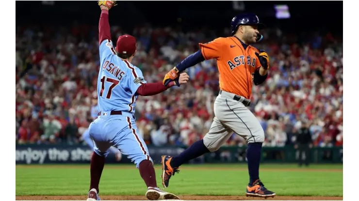 Jose Altuve of the Houston Astros is forced out at first base by Rhys Hoskins of the Philadelphia Phillies
