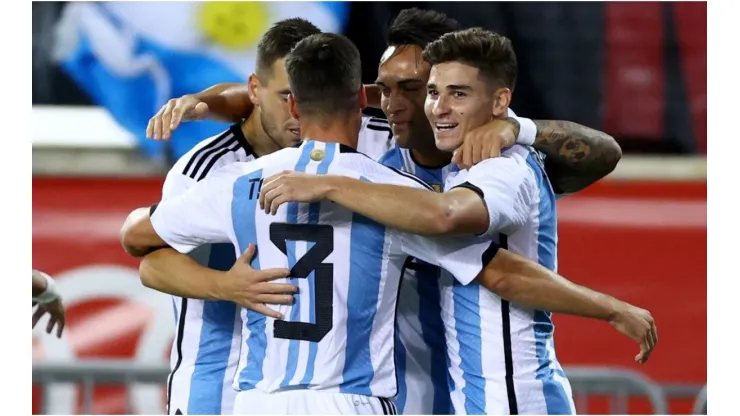 Julian Alvarez of Argentina is congratulated by teammates Nicolas Tagliafico,Giovani Lo Celso and Lautaro Martinez
