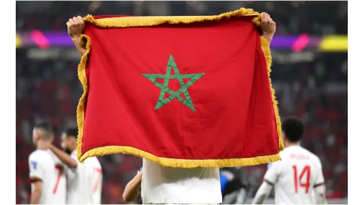 A player hold the national flag of Morocco
