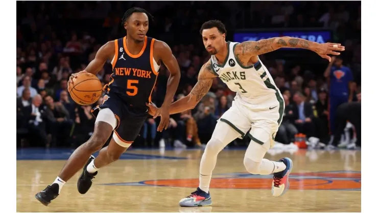 Immanuel Quickley of the New York Knicks drives to the net against George Hill of the Milwaukee Bucks
