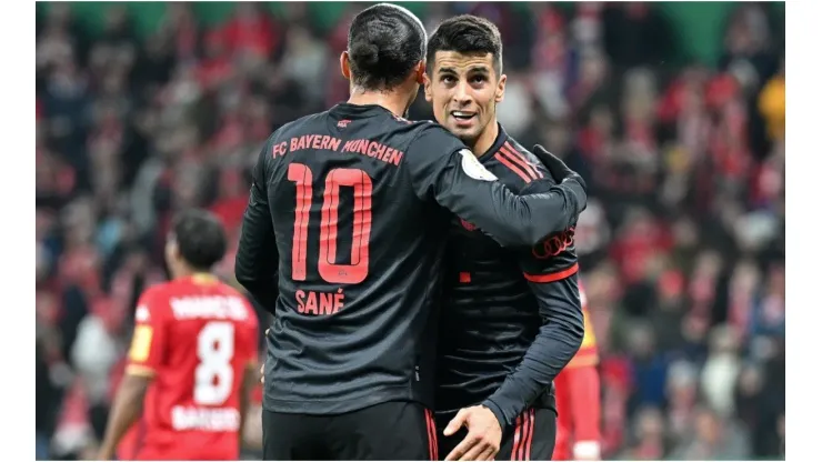 Leroy Sane of Bayern Munich celebrates with Joao Cancelo
