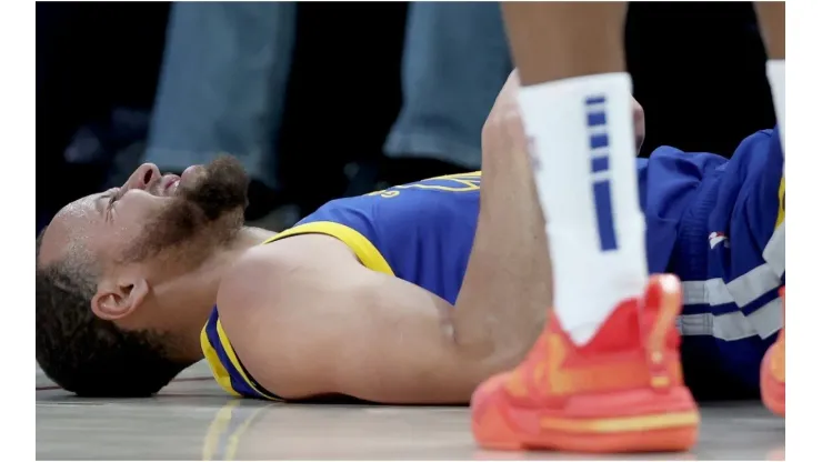 Stephen Curry #30 of the Golden State Warriors is knocked to the floor
