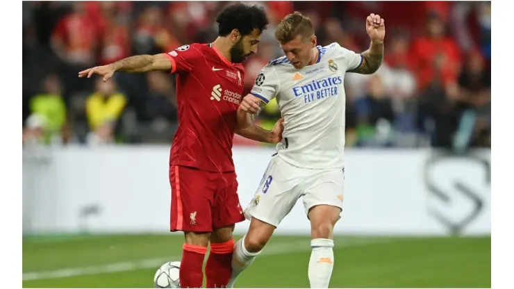 Mohamed Salah of Liverpool battles for possession with Toni Kroos of Real Madrid
