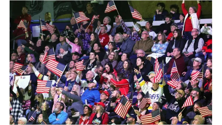 Fans wave American flags
