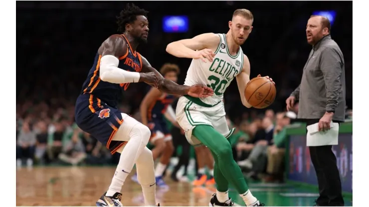 Julius Randle #30 of the New York Knicks defends Sam Hauser #30 of the Boston Celtics
