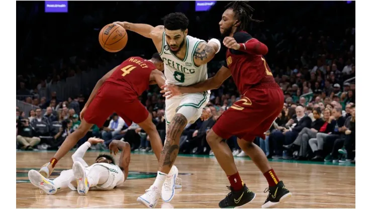 Jayson Tatum #0 of the Boston Celtics drives on Darius Garland #10 of the Cleveland Cavaliers
